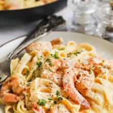 plated Shrimp Alfredo with pan full in the back