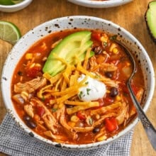 chicken enchilada soup in a bowl with a spoon