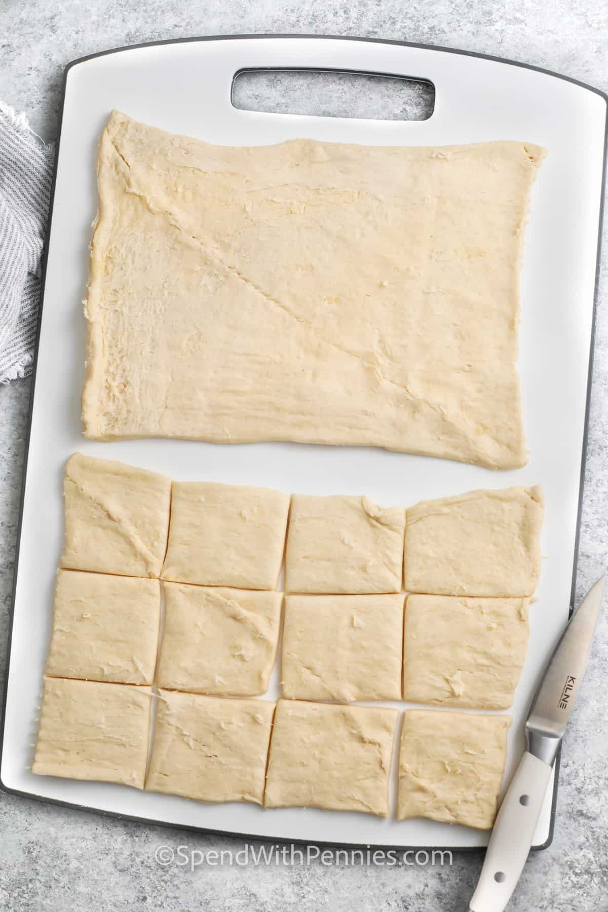 slicing crescent roll dough to make Cranberry Brie Bites