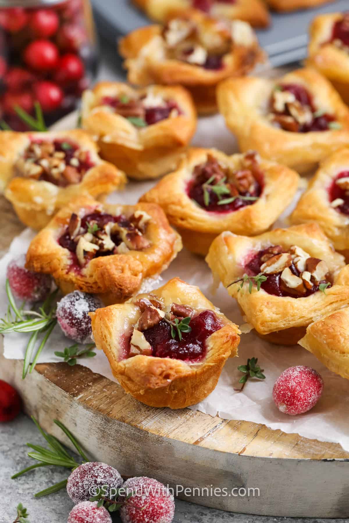 Cranberry Brie Bites on a wooden platter