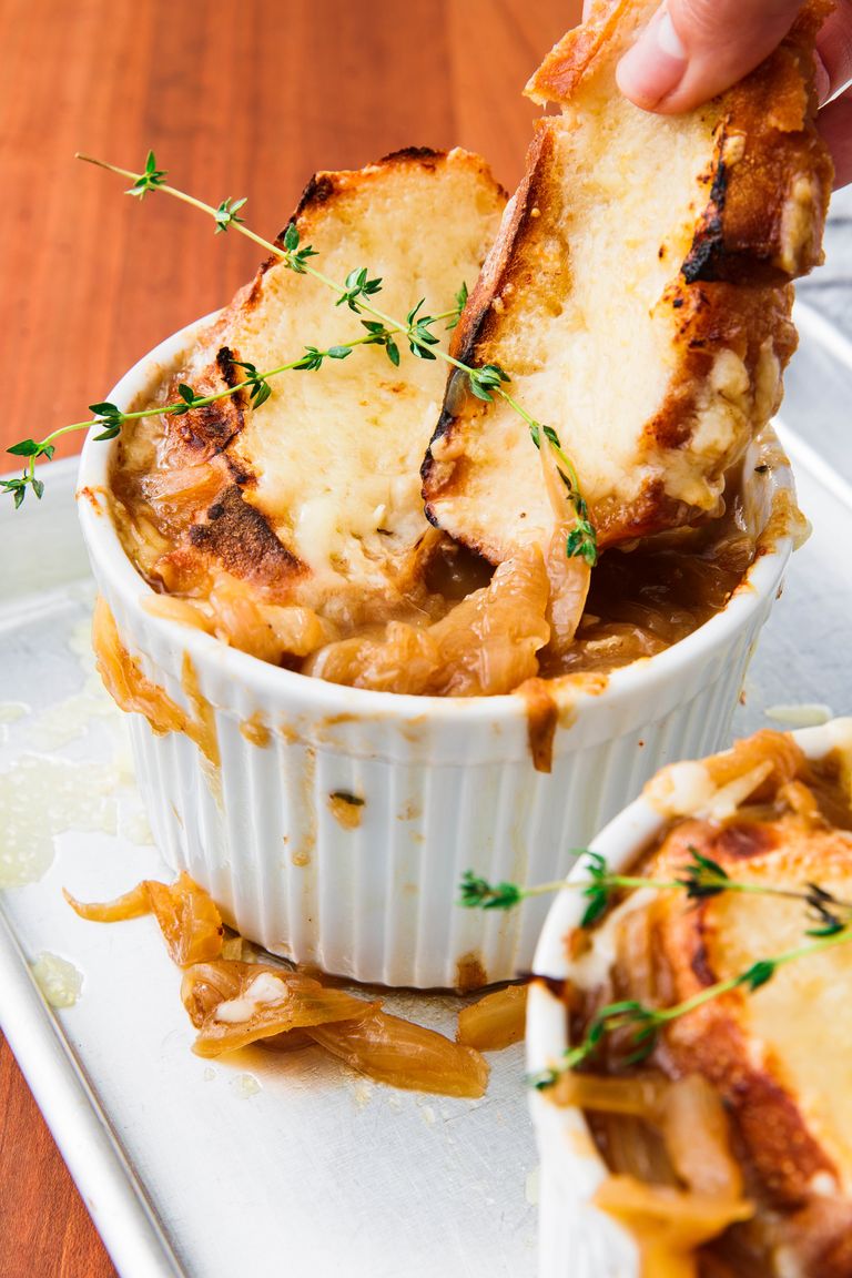 Fall Soup Recipes: A rich bowl of freshly made French onion soup sits on a baking tray.