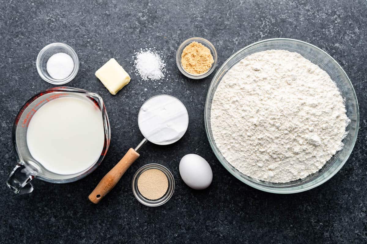 An overhead view of the ingredients needed to make homemade pretzel rolls.