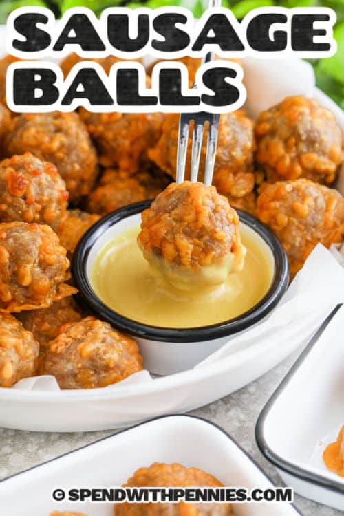 Sausage Balls with one on a fork with dip and a title