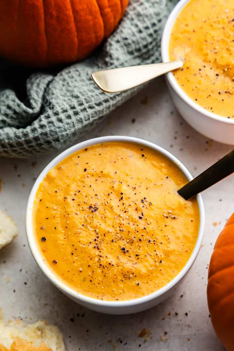 An overhead view of a bowl of pumpkin soup.