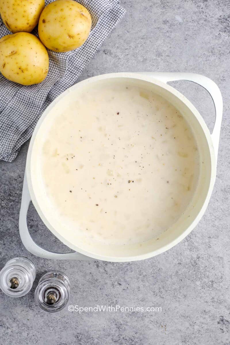 A small pot of sauce for scalloped potatoes sauce