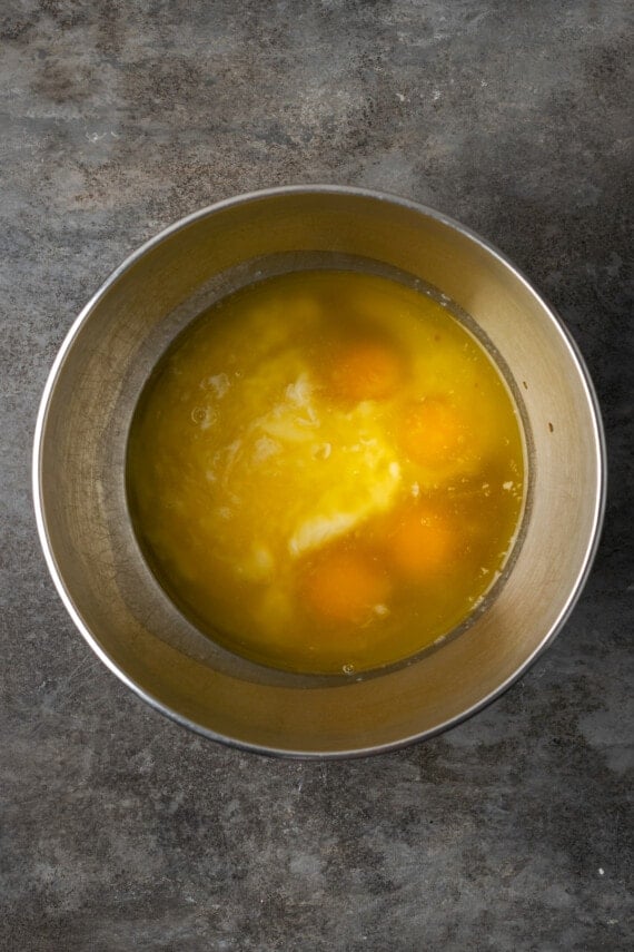 Wet cupcake ingredients combined in a metal mixing bowl.